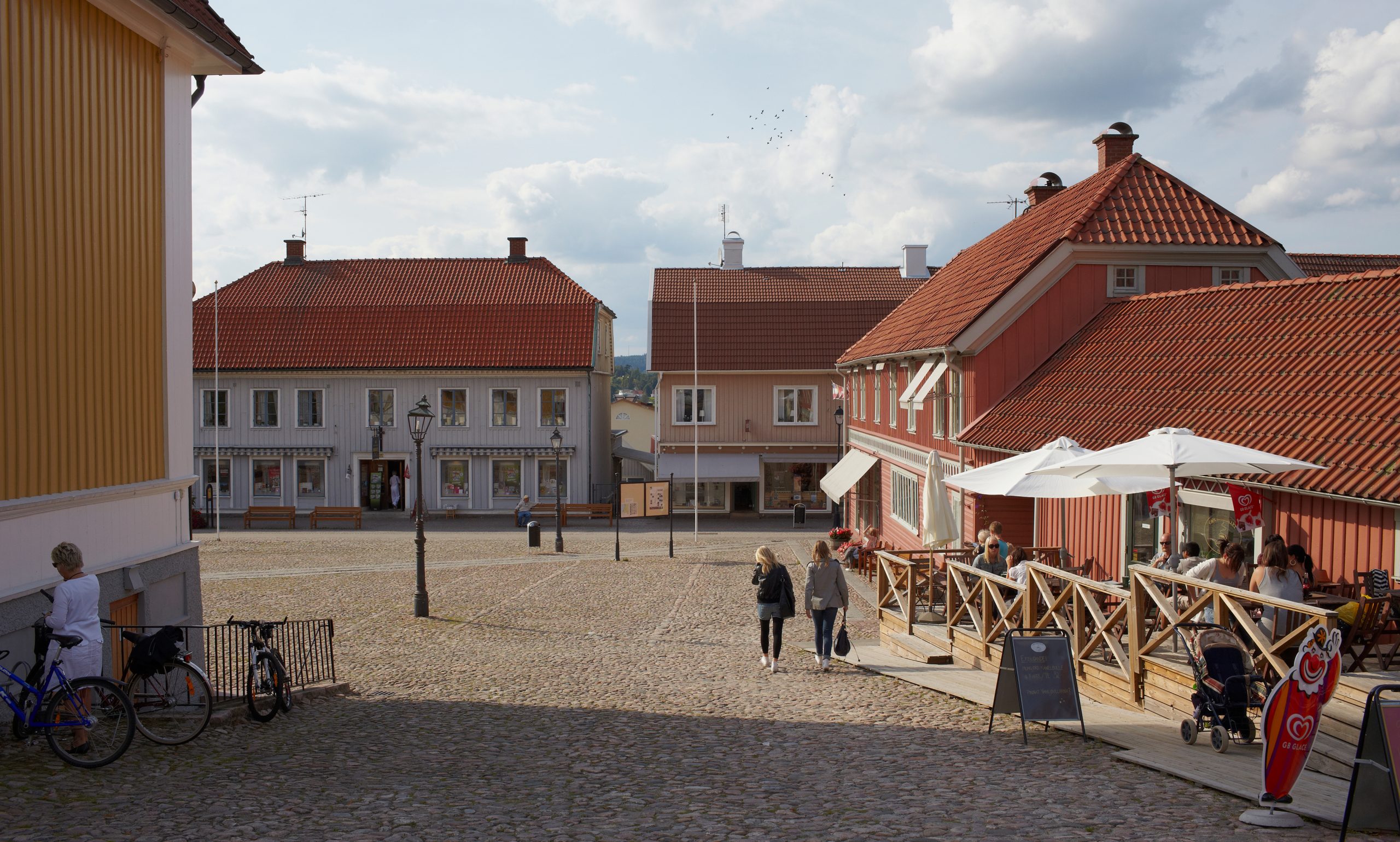 iIld på stora torget i Ulricehamn med gammal bevarad träbyggnad samt kullersten på marken. 
